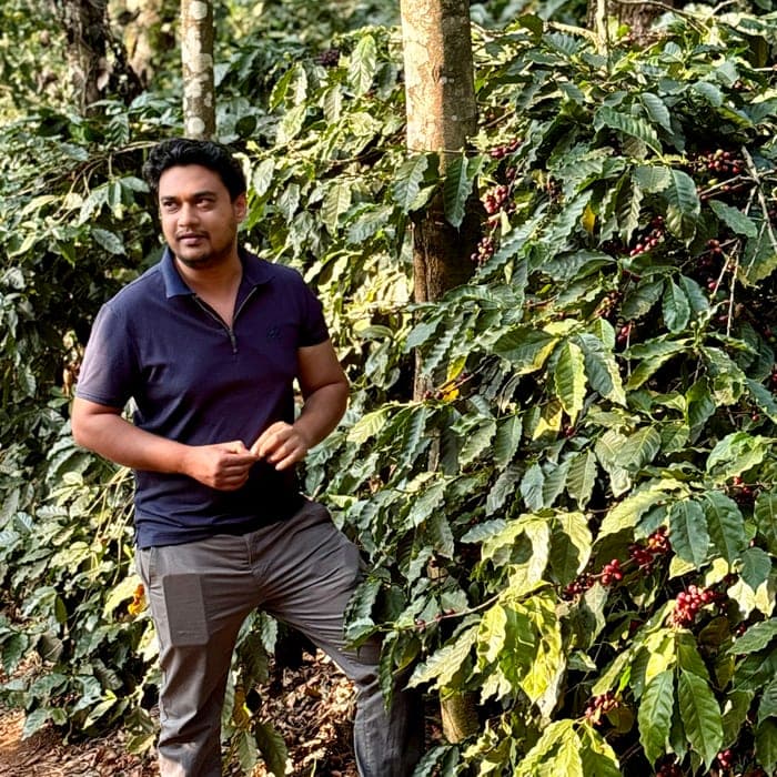 Saif Ulla among the coffee rows at Gundikhan Estate